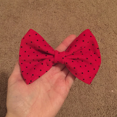 picture of a red fabric bow made with thrifted fabric