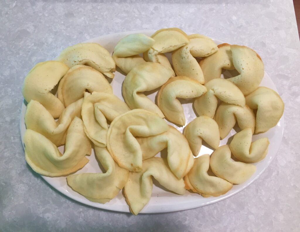 A picture of a plate of homemade fortune cookies