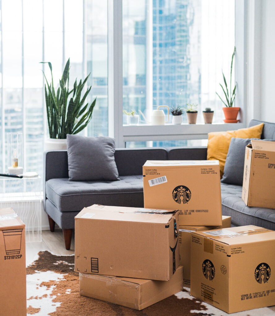 A picture of an apartment with moving boxes in the living room