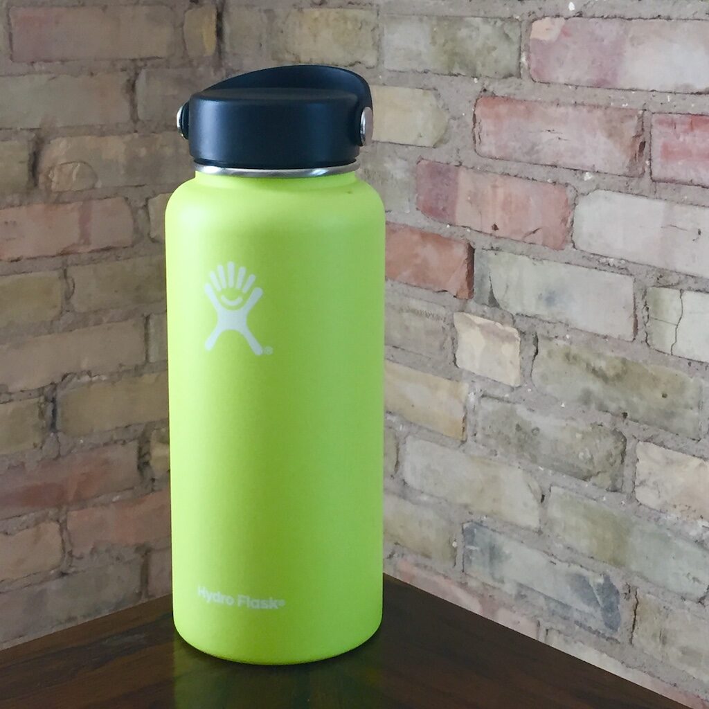 A picture of a neon green HydroFlask reusable water bottle