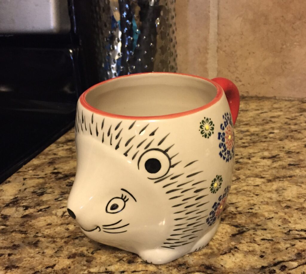 A picture of a thrifted hedgehog coffee mug
