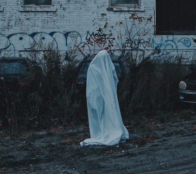 A picture of a person in a ghost Halloween costume