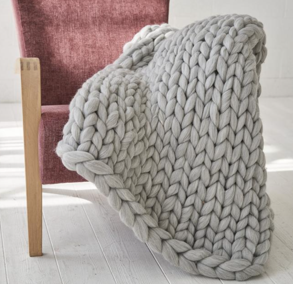 A picture of an arm knit gray wool blanket