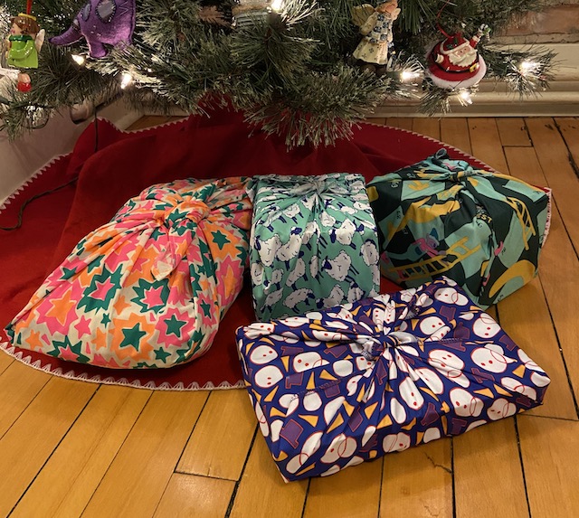A picture of presents wrapped in reusable fabric gift wraps