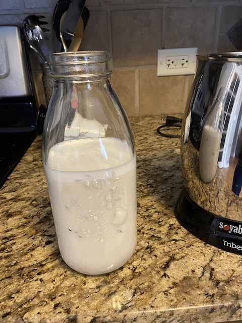 A glass jar of almond milk, made in the Soyabella nut milk maker