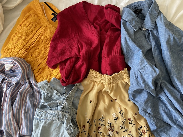 A picture of a bunch of clothes purchased on Thredup, an online thrift store