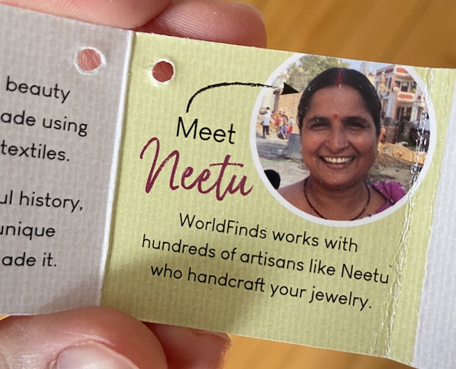 A picture of a WorldFinds artisan tag, showcasing the artisan who made the jewelry