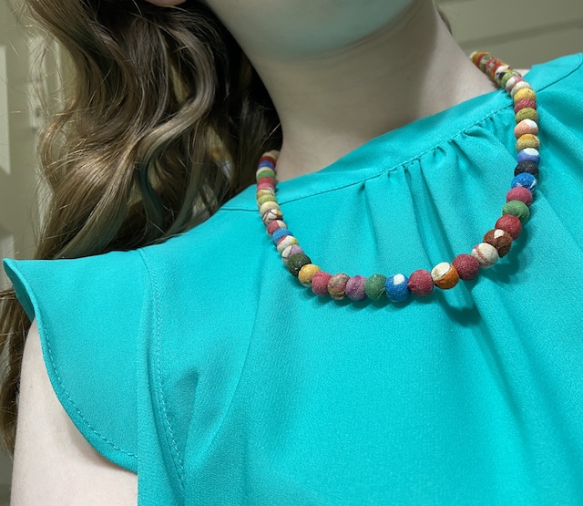 A picture of a girl wearing a classic Kantha Worldfinds necklace