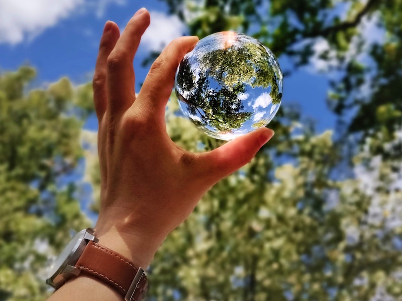 A picture of a hand holding a globe of the earth