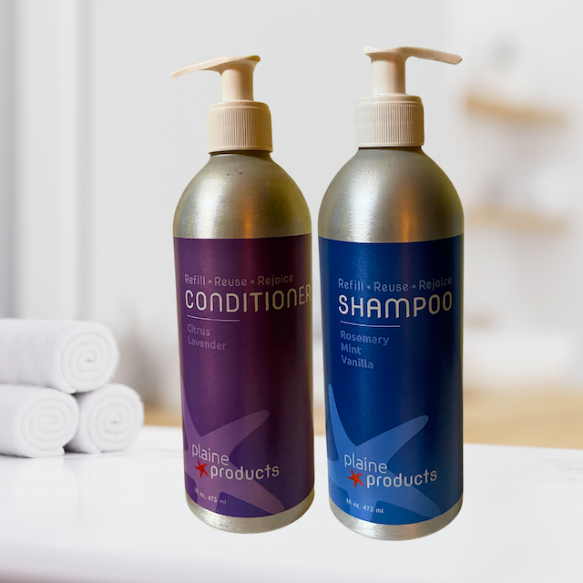 Plaine Products shampoo and conditioner on bathroom counter
